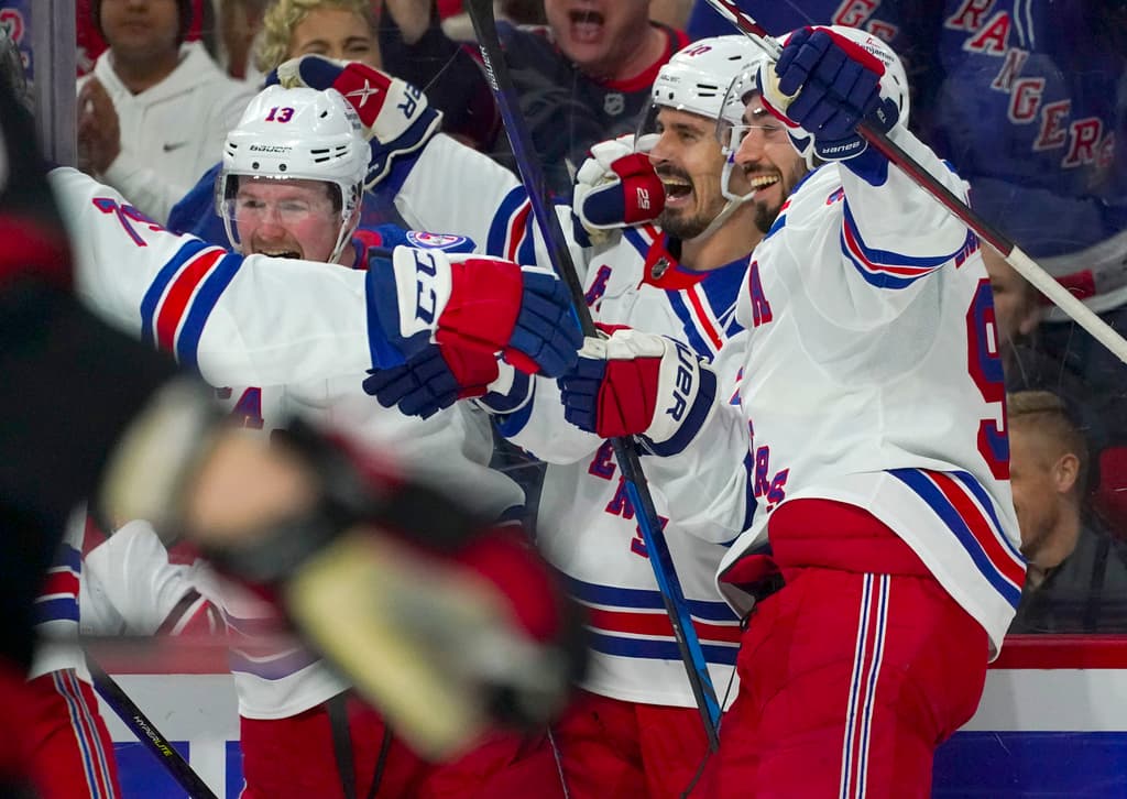 New York Rangers players celebrate a goal during a game against the Hurricanes