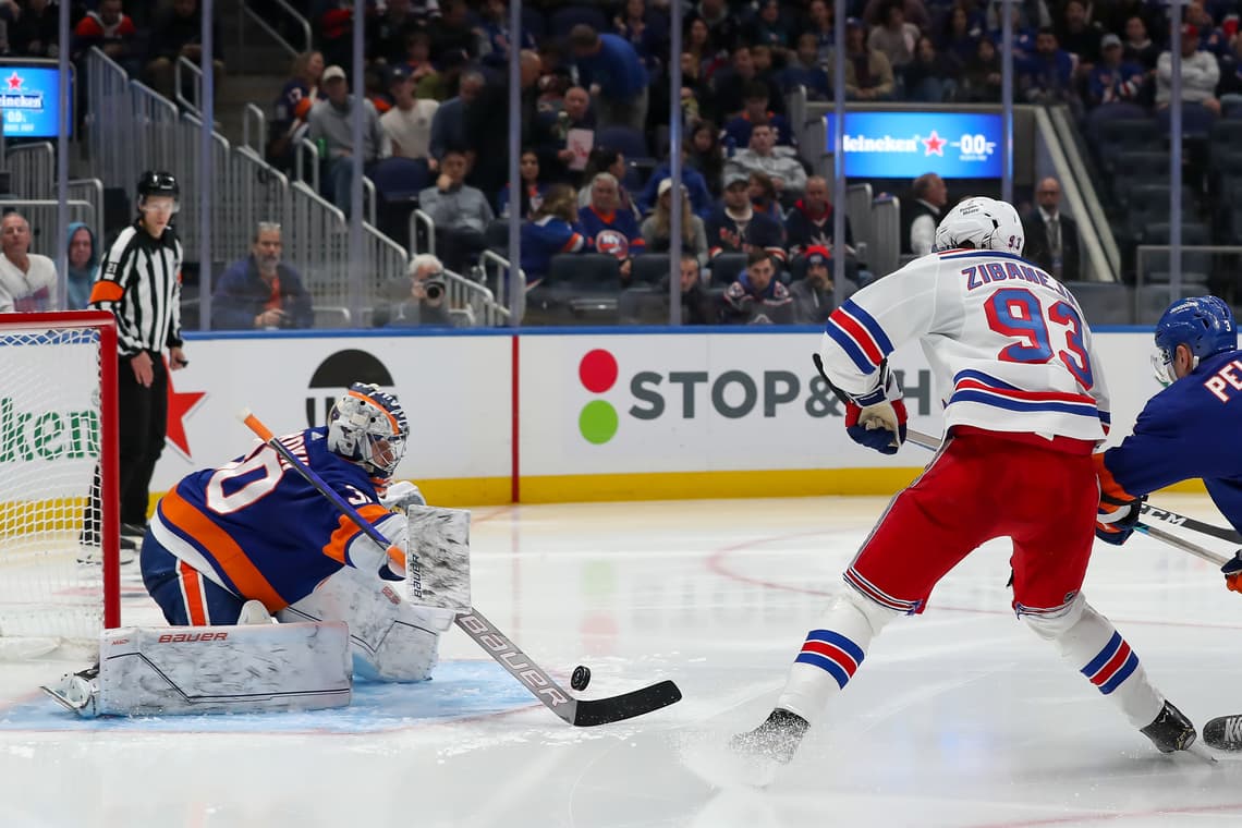 Rangers player Zibanejad shoots on Islanders goaltender during game at UBS Arena