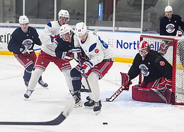 NY Rangers prospect, and first round draft pick, Alberts Šmits (63) works against Felix Farhammar (56) during a prospect