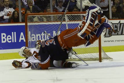 12/01/1999 Continental Arena- Devils Claude Lemieux collides in the goal with Ranger Goalie Mike Richter in the first period.