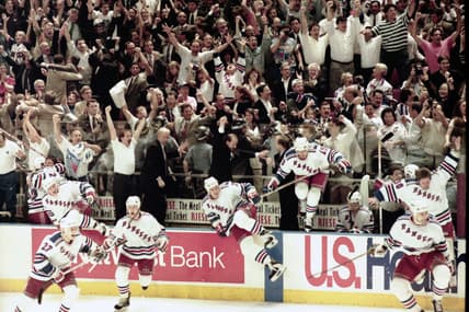 Rangers players jump from their bench as the final buzzer sounds in game 7 of the Stanley Cup Finals at Madison Square Garden