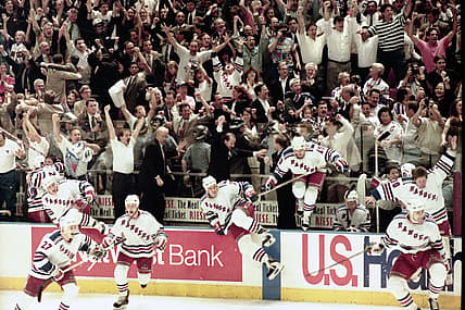 Rangers players jump from their bench as the final buzzer sounds in game 7 of the Stanley Cup Finals at Madison Square Garden
