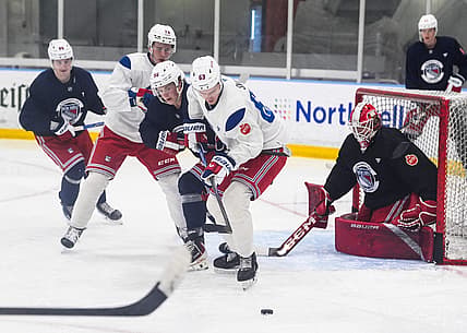 NY Rangers prospect, and first round draft pick, Alberts Šmits (63) works against Felix Farhammar (56) during a prospect