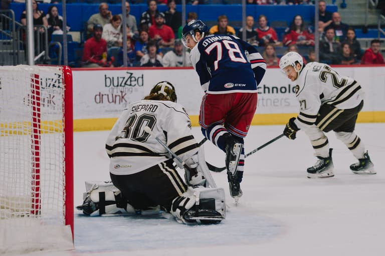 Brennan Othmann skating with the puck against Hartford Wolf Pack goalie Sheppard