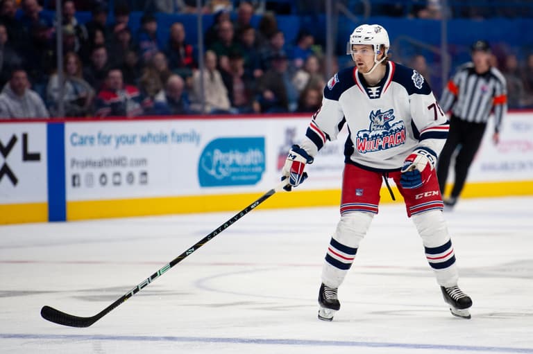 Wolf Pack player in white jersey during AHL game