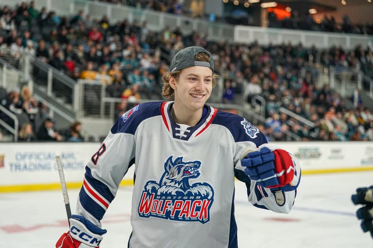 Hartford Wolf Pack player smiling on ice during preseason game