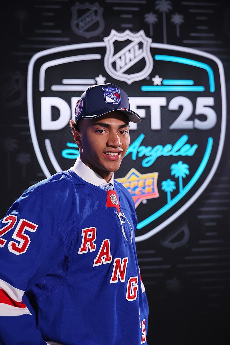 Young player wearing New York Rangers jersey at 2025 NHL Draft in Los Angeles