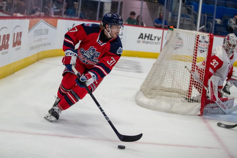Nathan Sucese skating with the puck during a Hartford Wolf Pack game