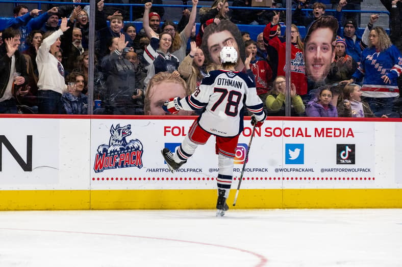Othmann celebrates a goal during Hartford Wolfpack game with fans cheering