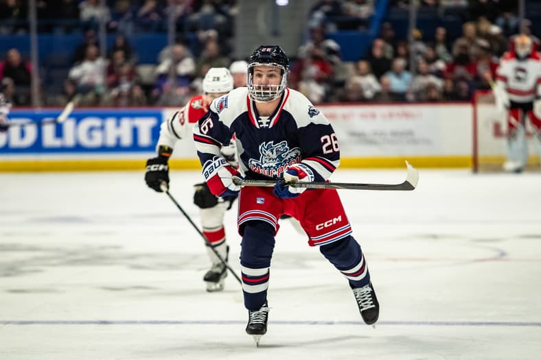 Hockey player in Hartford Wolf Pack uniform number 26 skating during game
