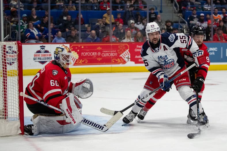 Hartford Wolf Pack goaltender makes a save during game action against opposing team.