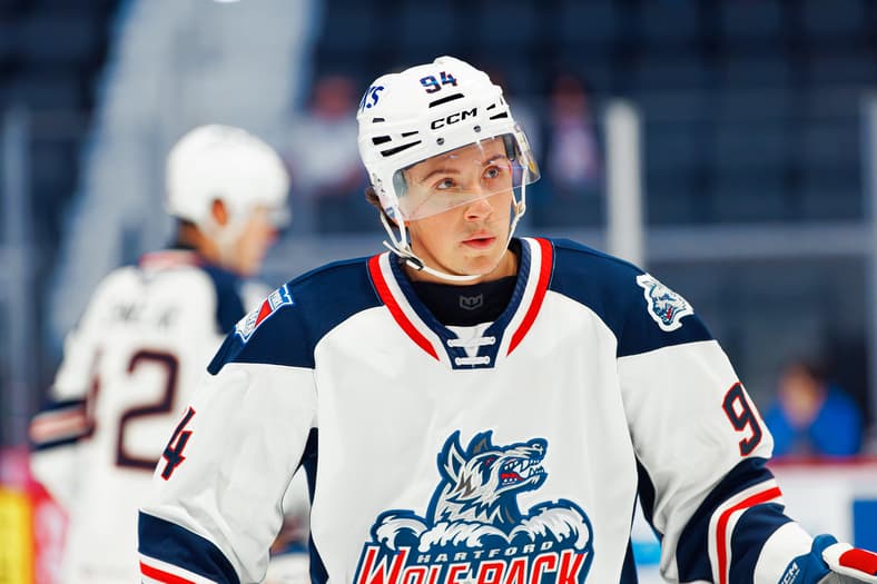 Hartford Wolf Pack player #94 in white jersey during game action