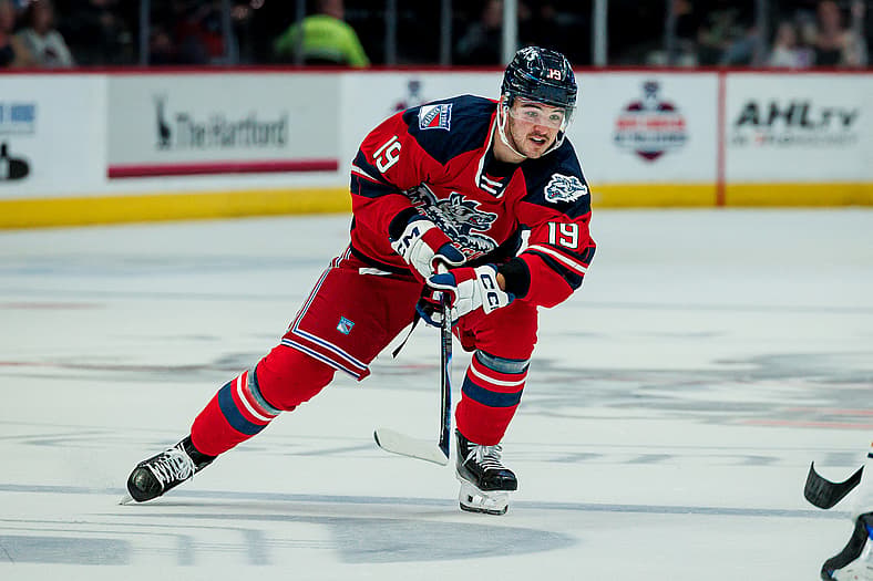 Brendan Brisson in Hartford Wolf Pack red jersey during AHL game